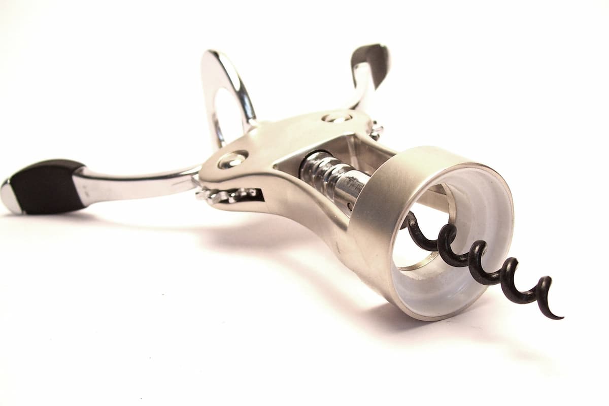 Close-up shot of a metal corkscrew on a white background. 
