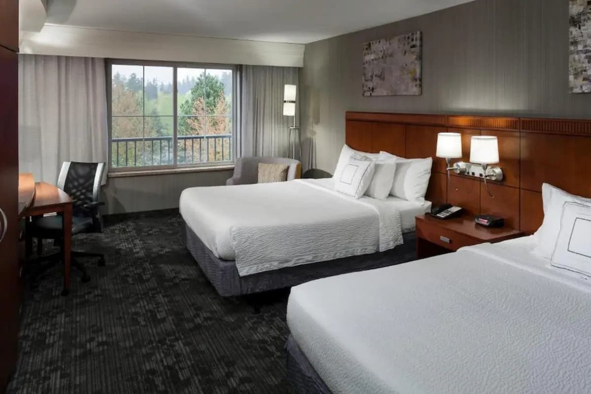 A room with two queen beds at Courtyard by Marriott Seattle Kirkland. 