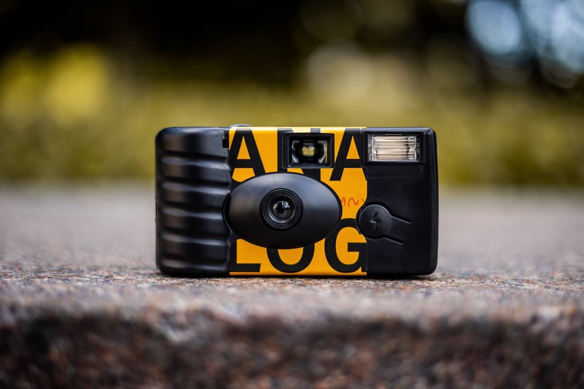 Close-up shot of a black and yellow disposable camera.