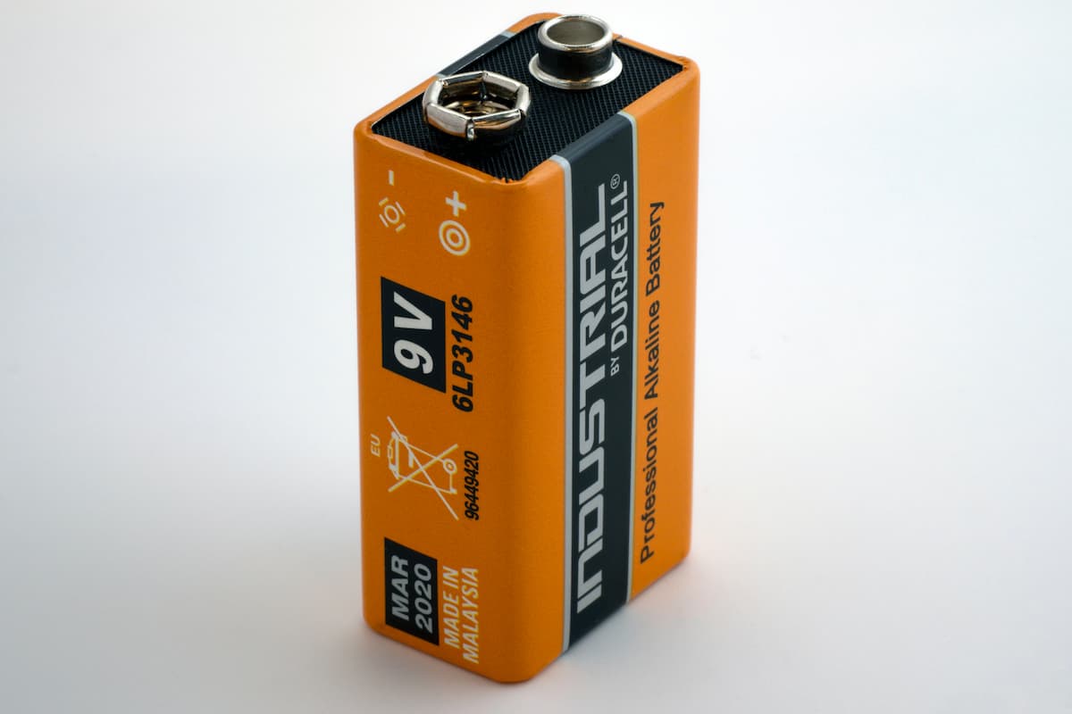 Orange Duracell 9V battery on a white background. 