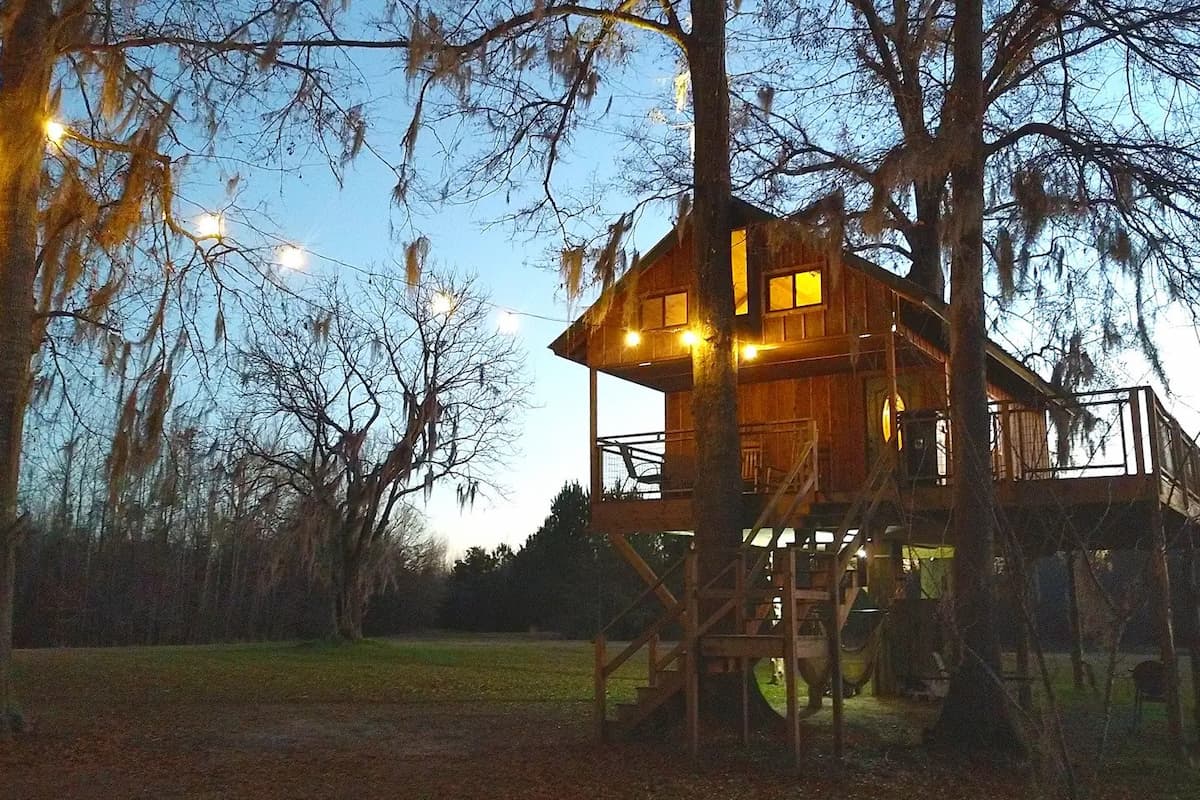 View of Family Size Treehouse from the outside during sunset. 