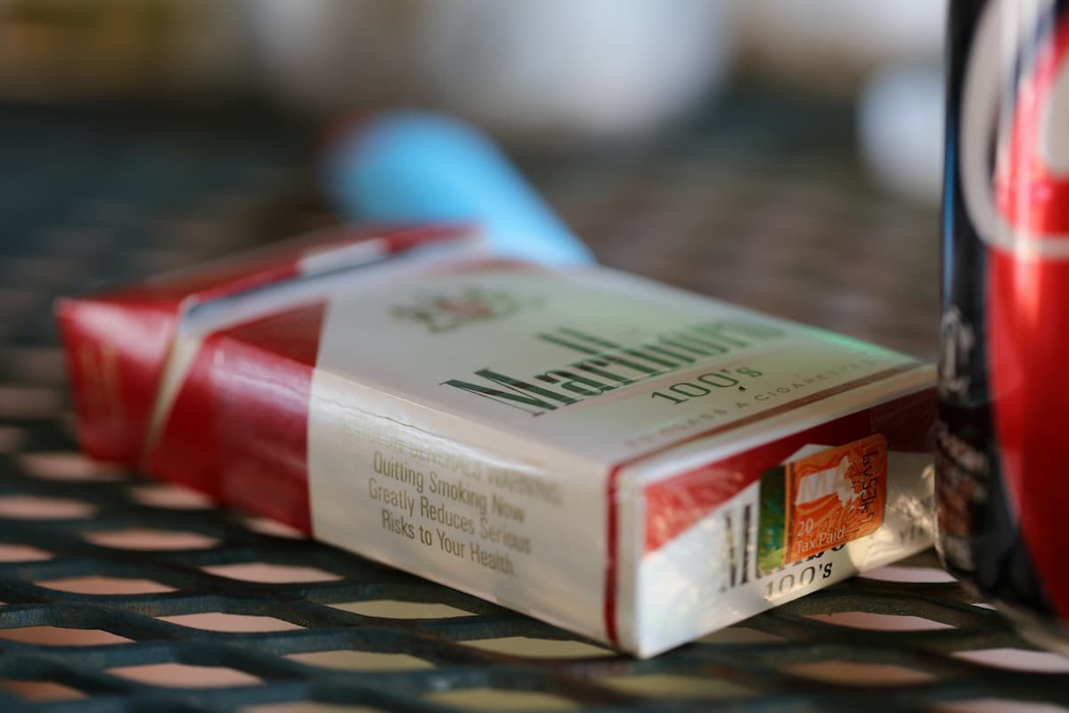 A pack of Marlboro cigarettes is on the table. 