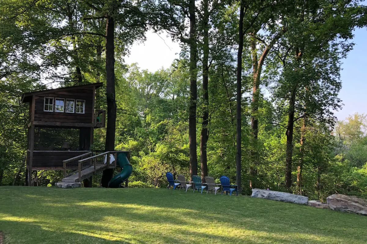 Wide shot of Playful Treehouse showing the lawn and chairs. 