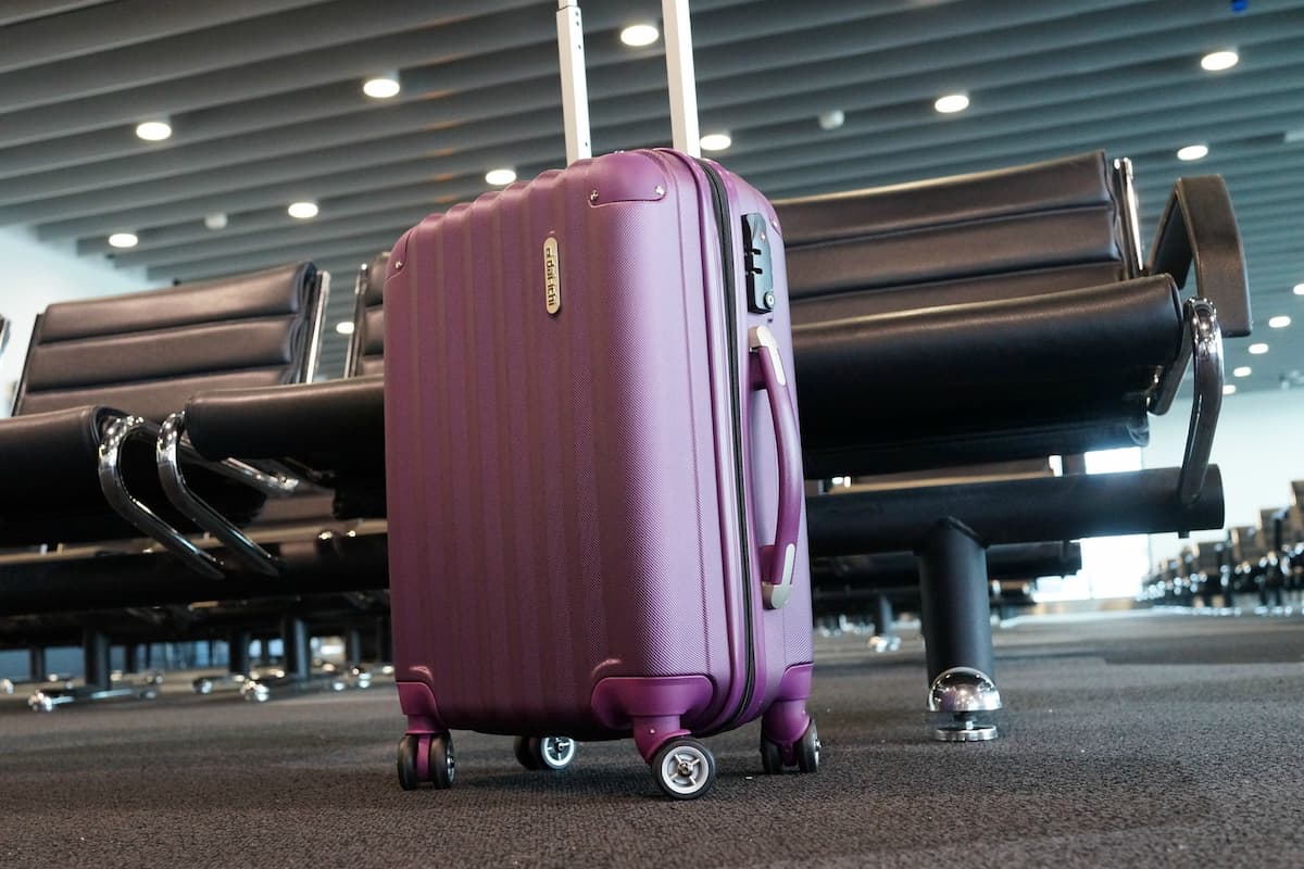 Purple luggage in an airport. 