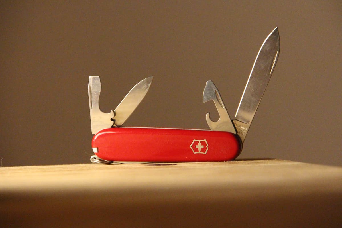Swiss knife on a wooden table. 