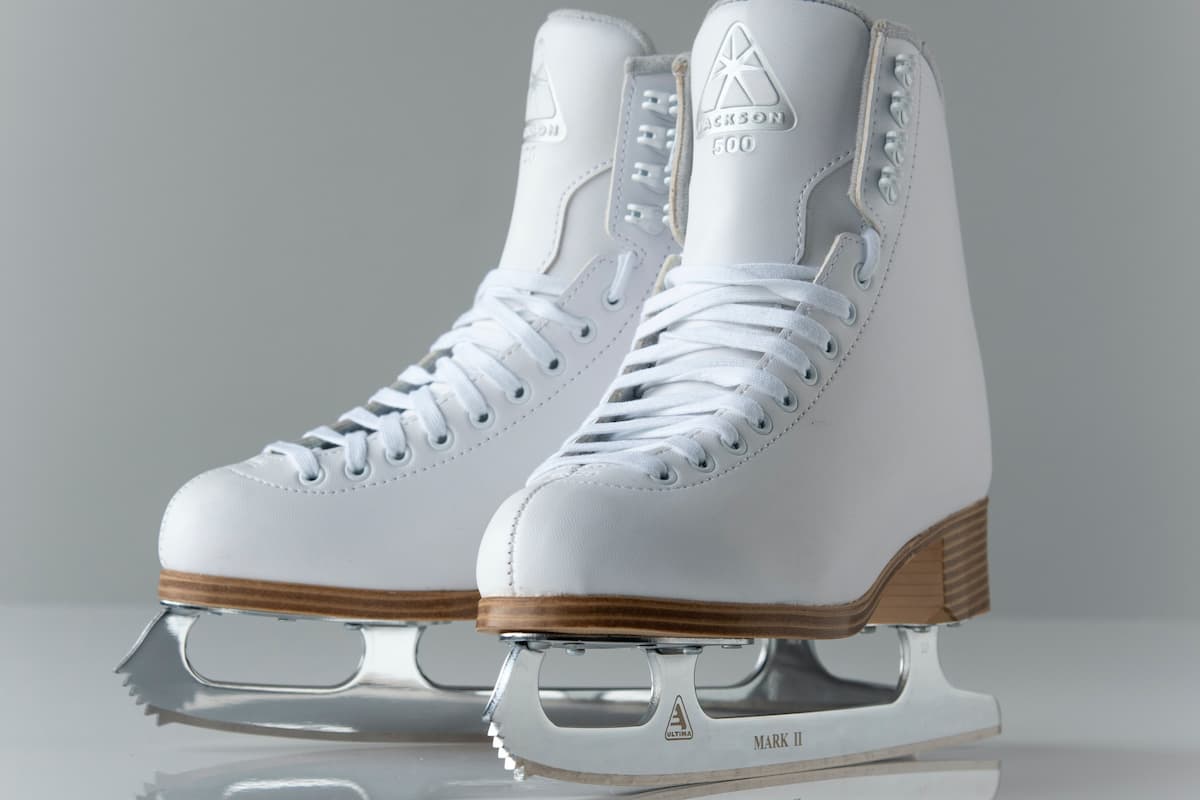 White ice skates on a white surface. 
