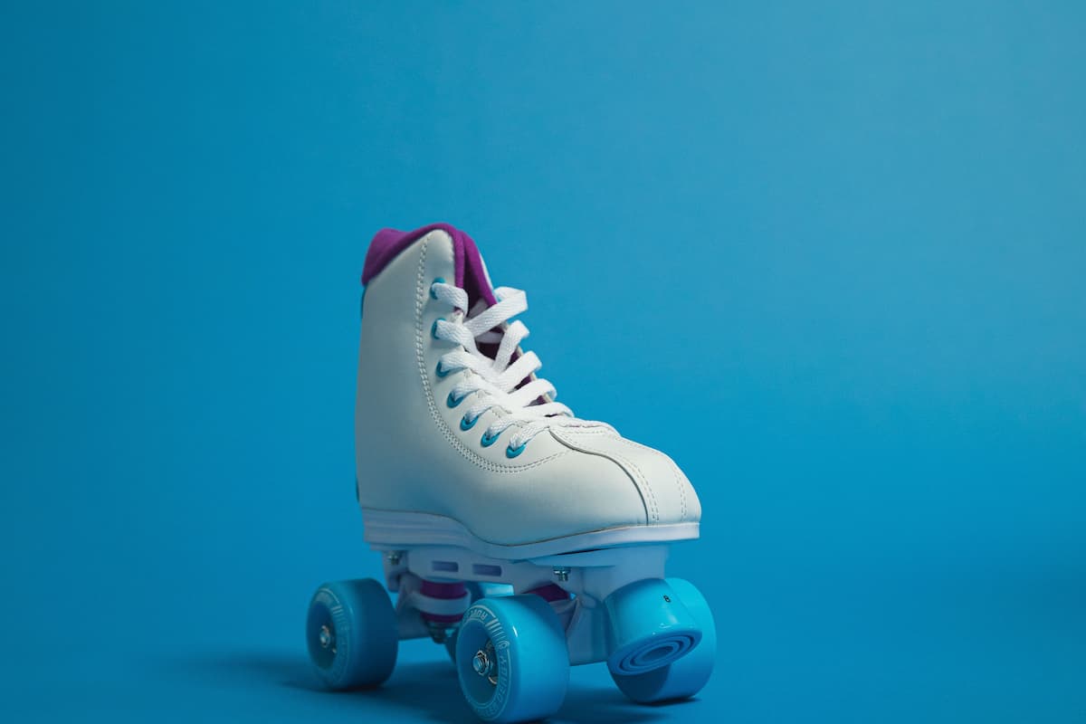 White and blue roller skates on a blue background. 