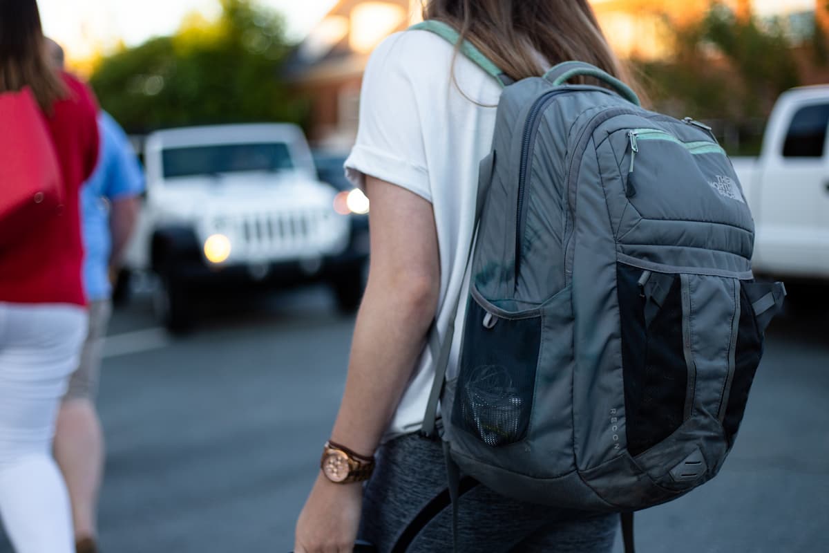 A woman wearing a gray backpack. 