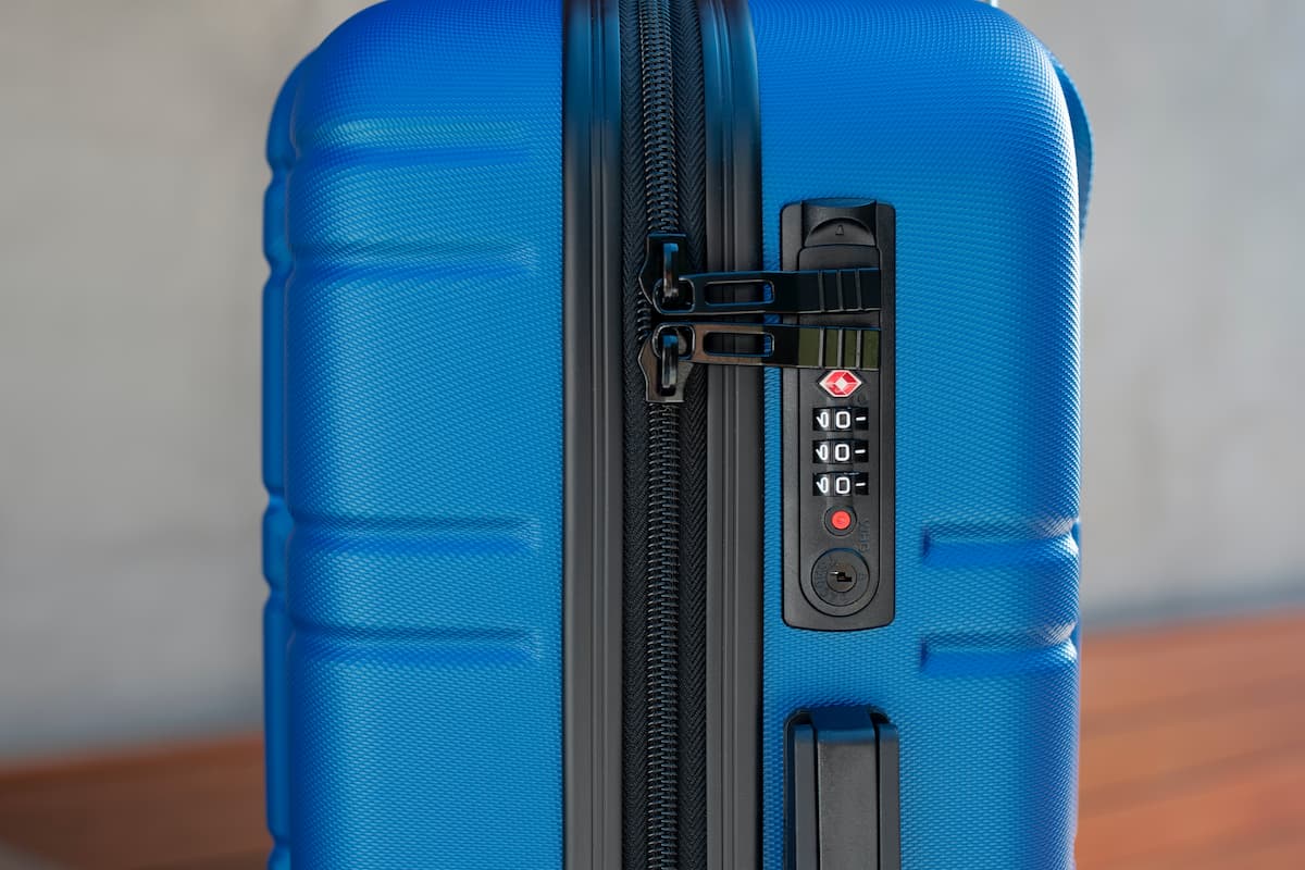 Close-up photo of blue luggage showing a TSA lock.