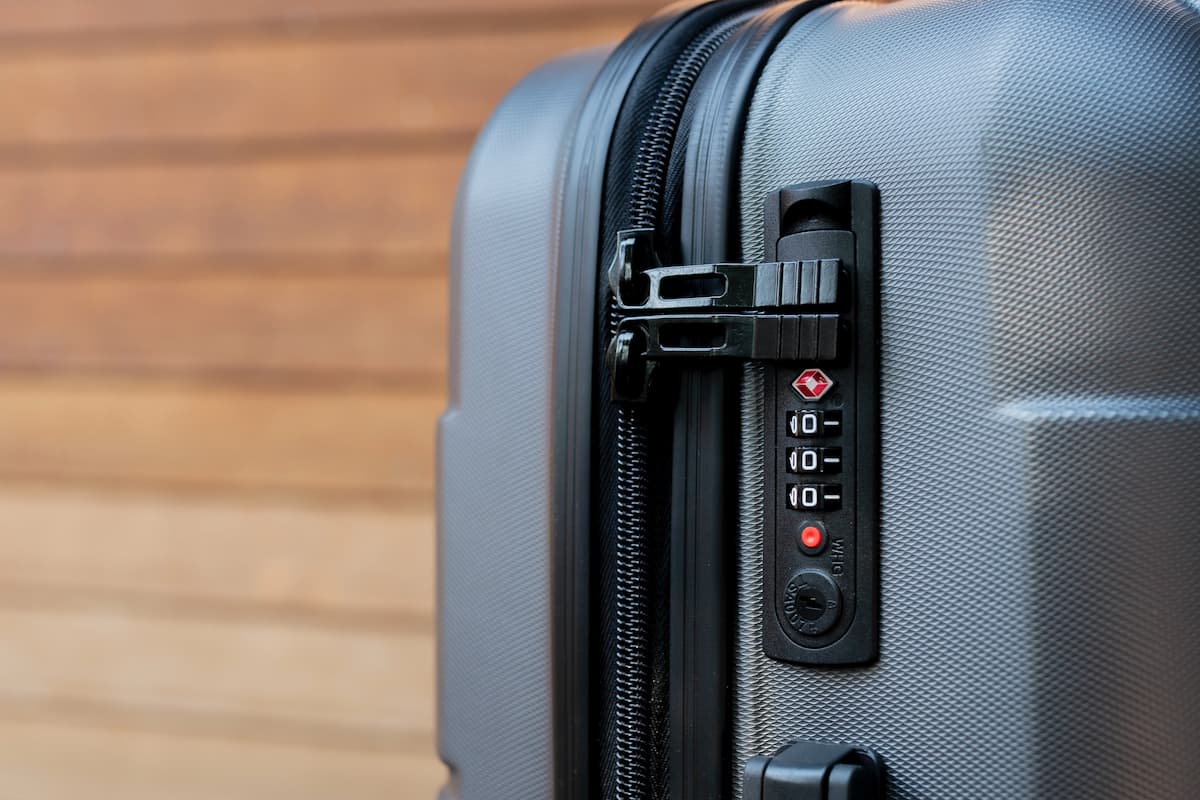 Close-up photo of gray luggage showing a TSA lock.
