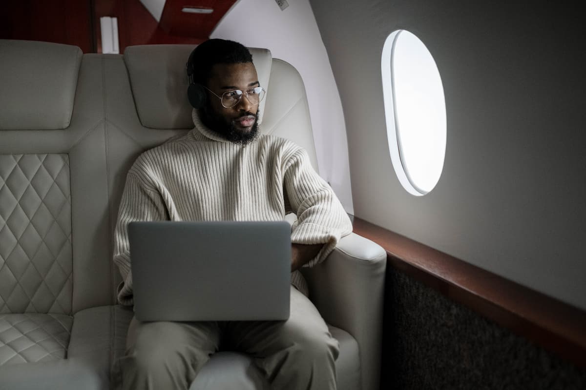 A man using a laptop on the plane.
