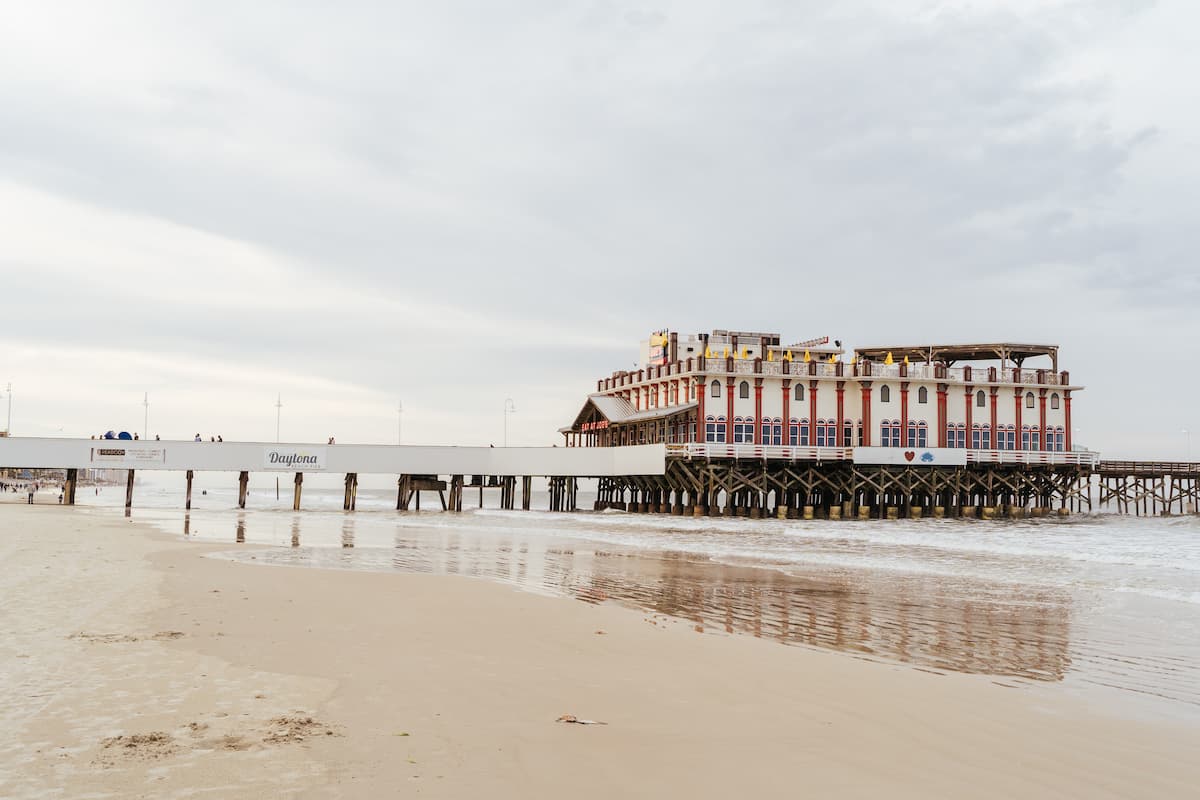 Red and white building on beach during daytime.