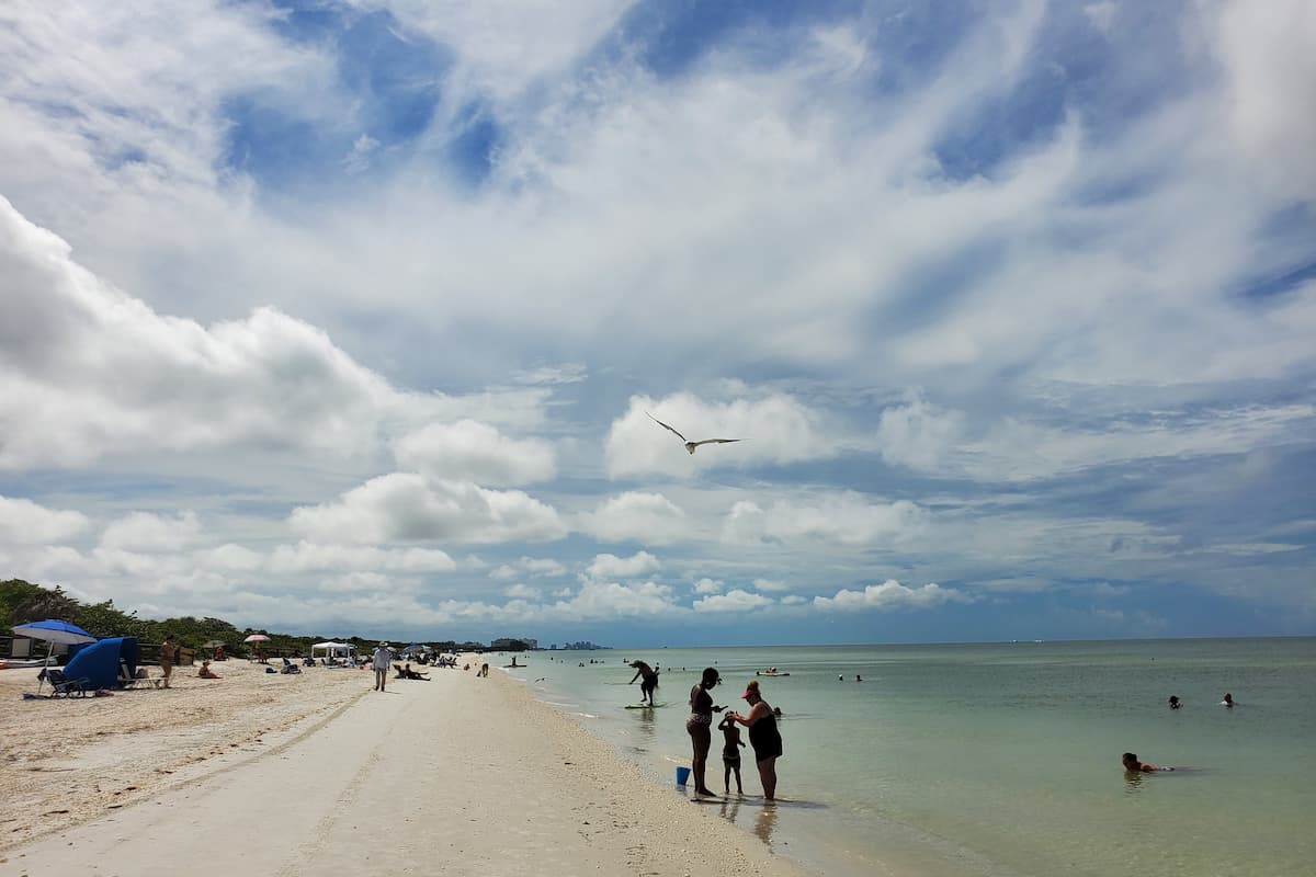 People swimming at Naples beach. 