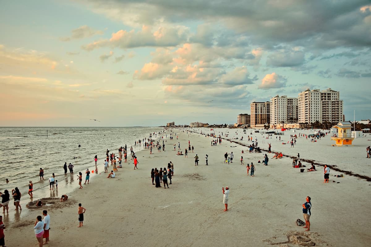 People enjoying the beach at Clearwater, Florida during sunset. 