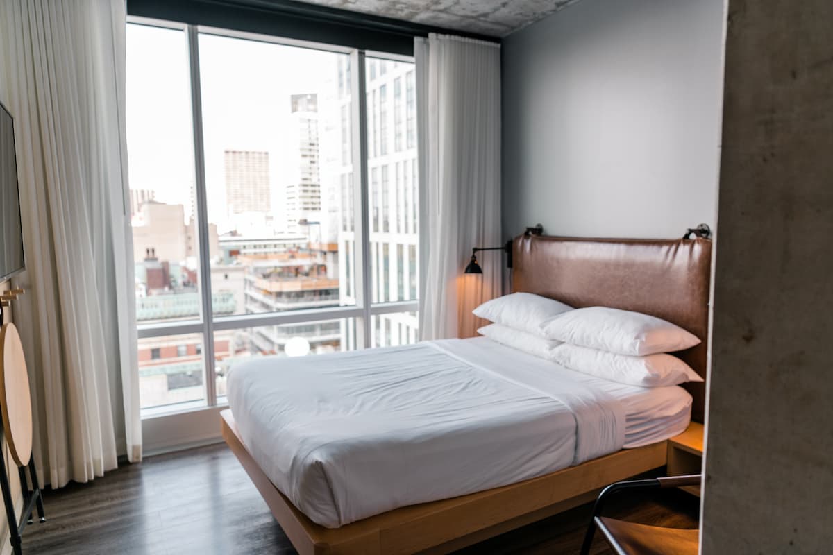 Boston City hotel room interior with a city view.