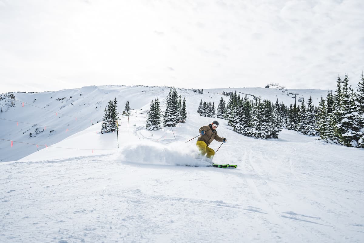 A man skiing in a ski resort.